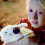 Celia holds a pet rabbit in the film Celia